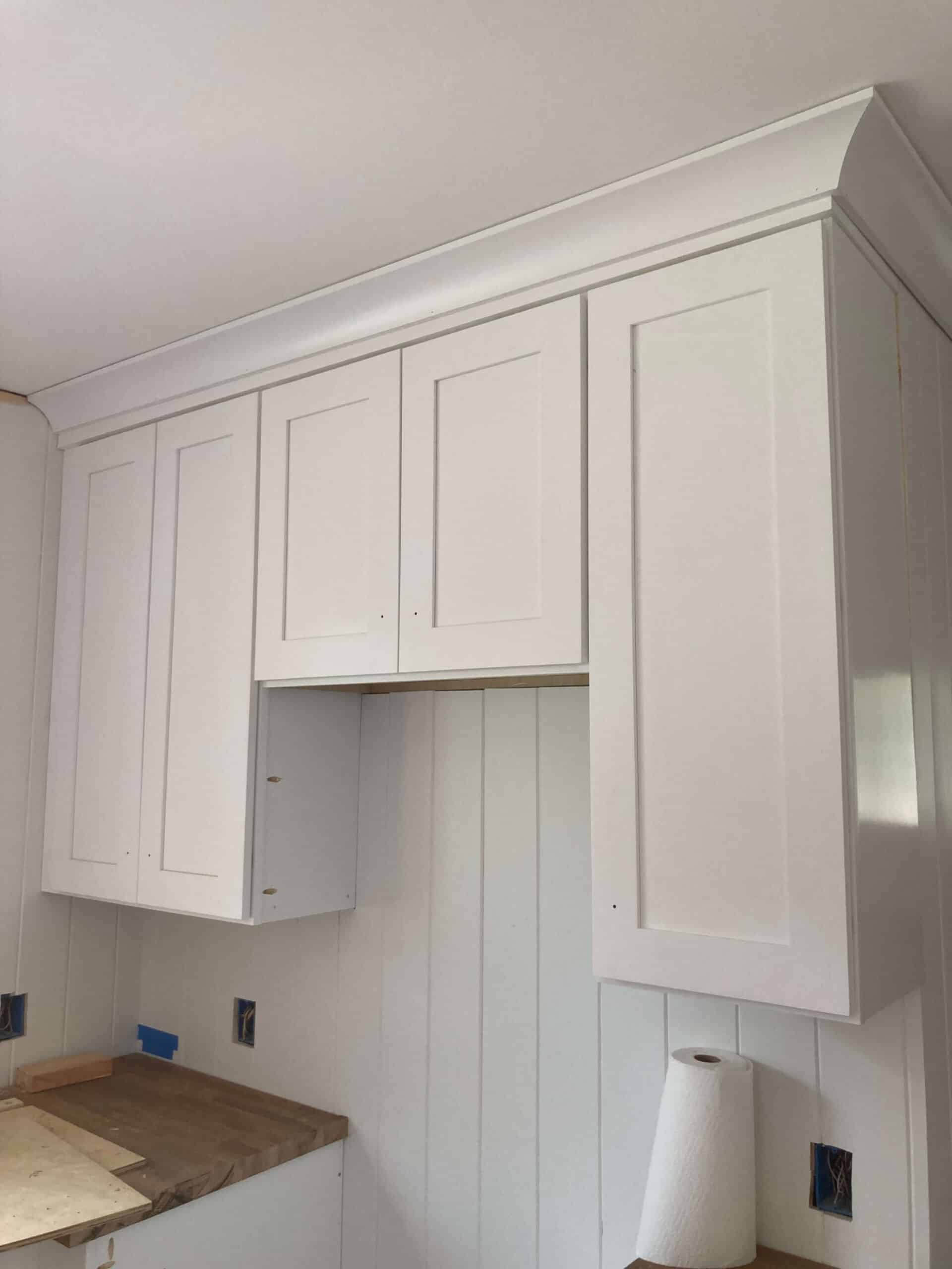 new white shaker cabinets hung in a kitchen